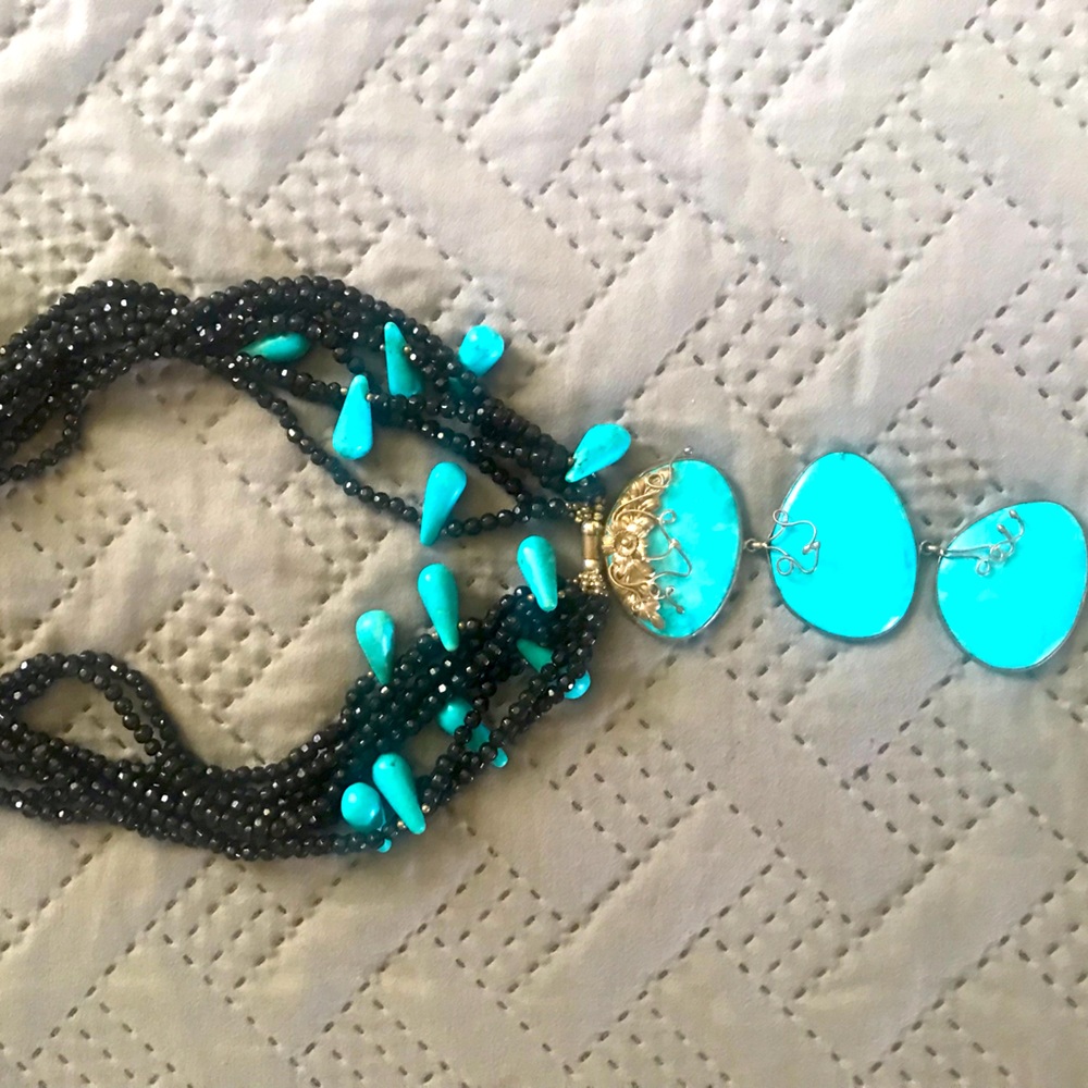 Handmade necklace from Kenya. Made with black beads and turquoise,silver detail.